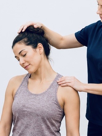 A TRUForm provider performing a gentle neck assessment at Texas Functional Health Centers in Dallas, TX