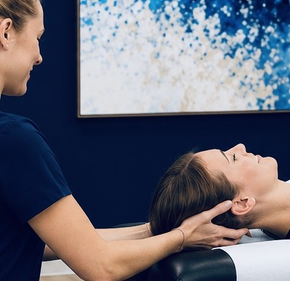 A TRUForm provider performing a gentle cervical adjustment at Texas Functional Health Centers in Dallas, TX