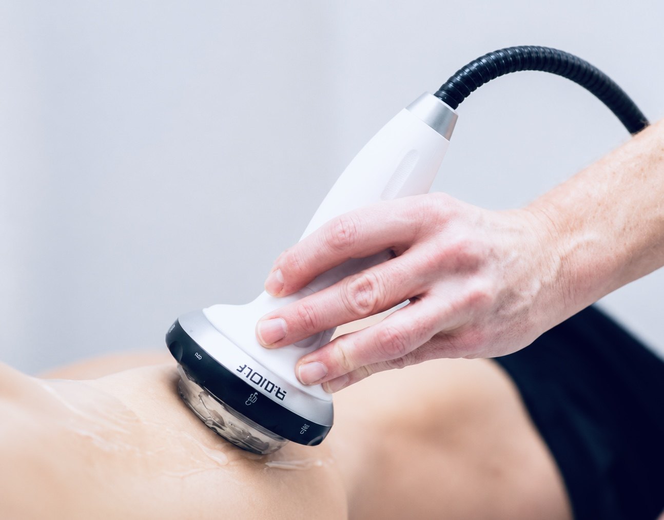 Radial shockwave therapy being applied to a patient at Texas Functional Health Centers in Dallas, TX